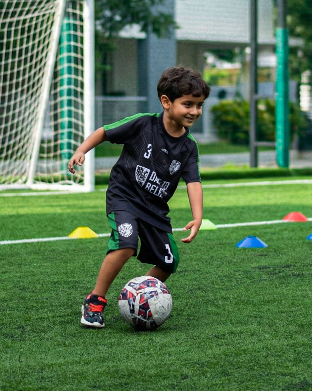 a toddler playing football